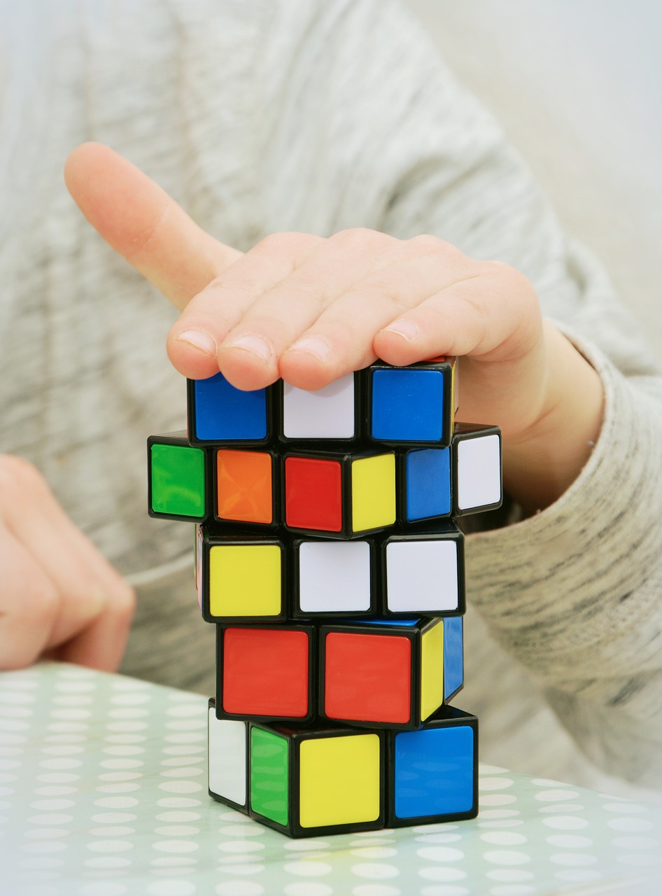 A man placing his hand in rubik's cube